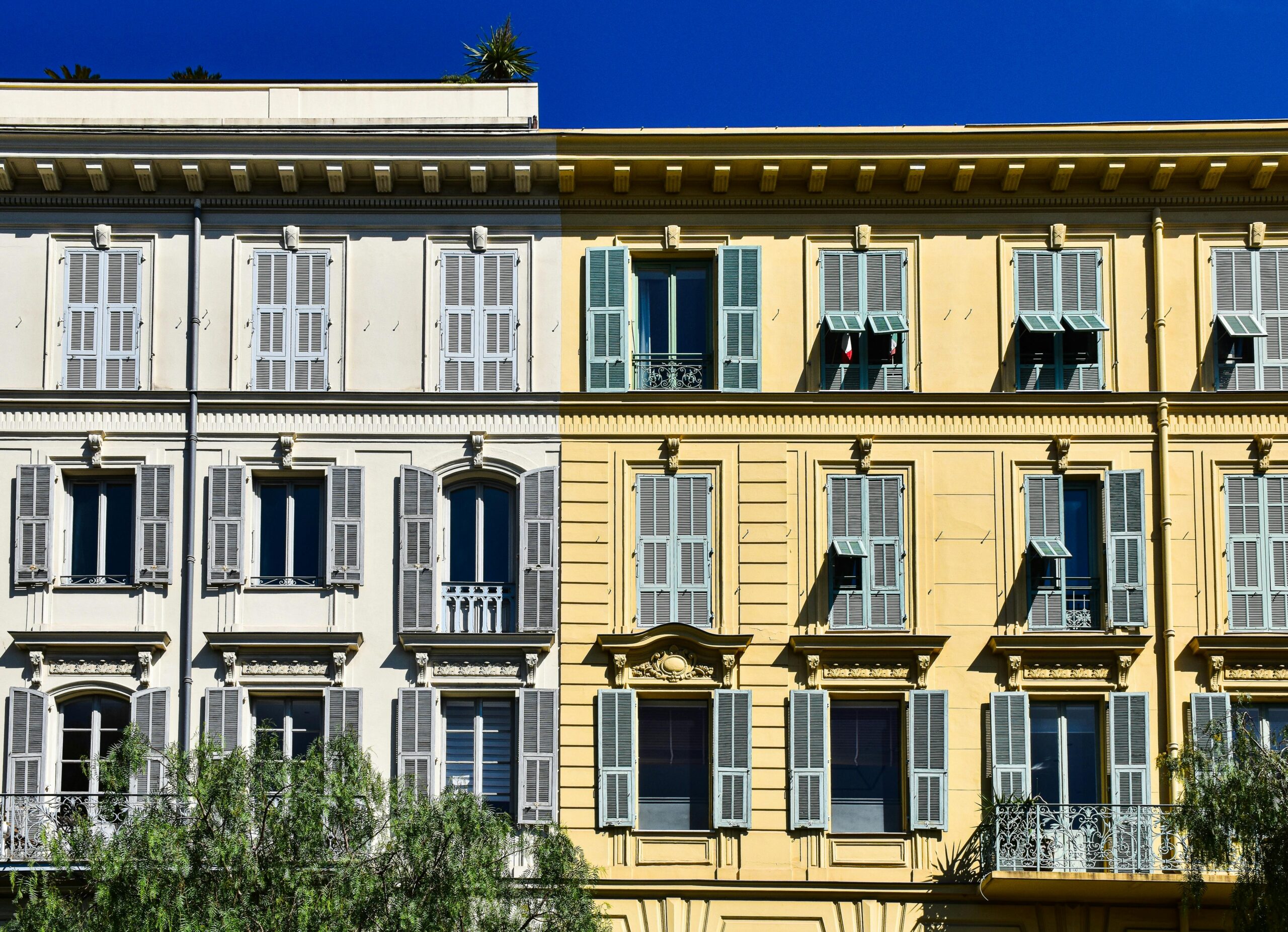 Vibrant building facade in the sunlit streets of Southern France's Provence region.